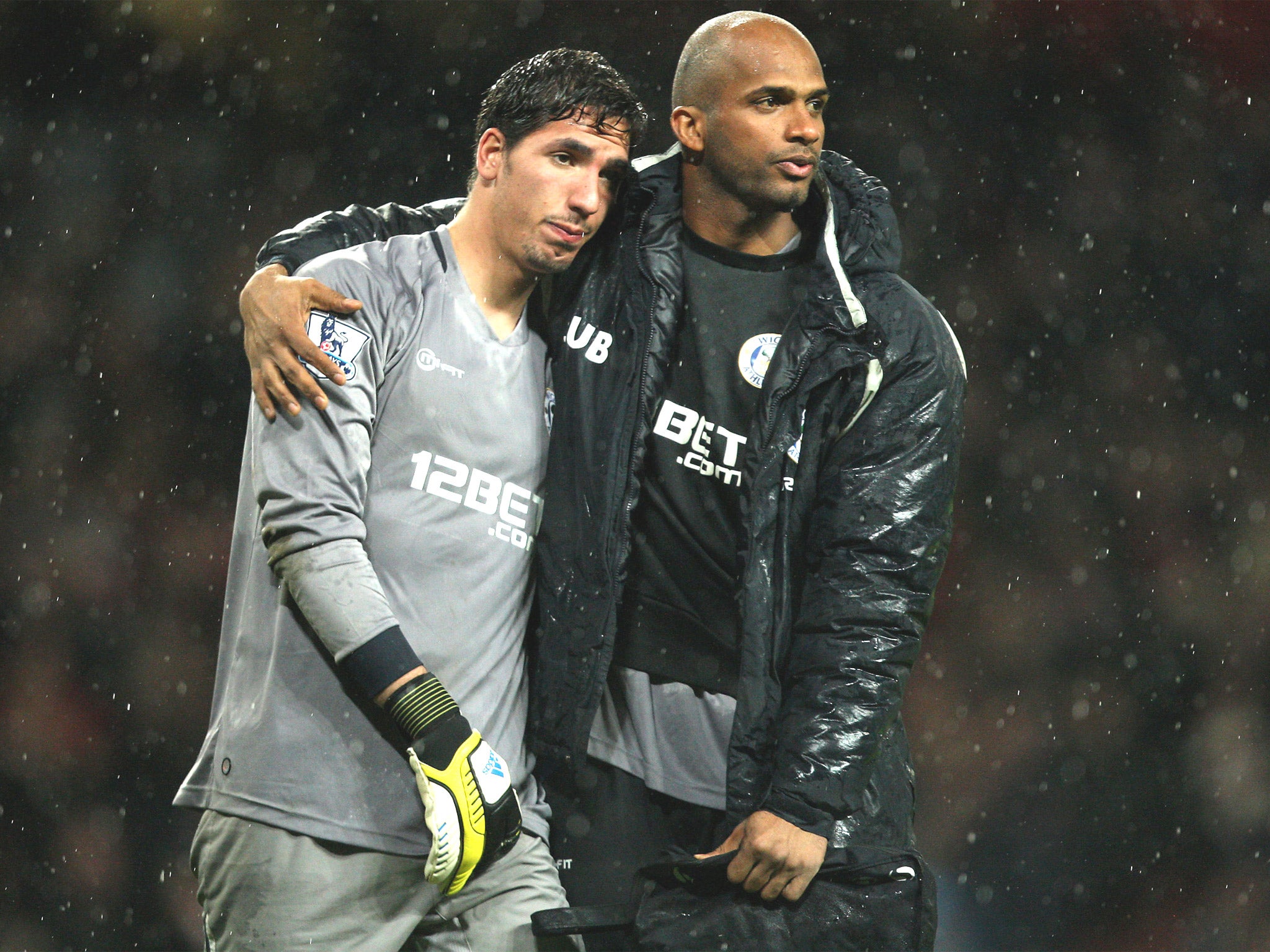 Wigan goalkeepers Joel Robles (left) and Ali Al-Habsi are dejected after their team’s relegation