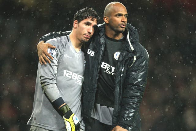 Wigan goalkeepers Joel Robles (left) and Ali Al-Habsi are dejected after their team’s relegation