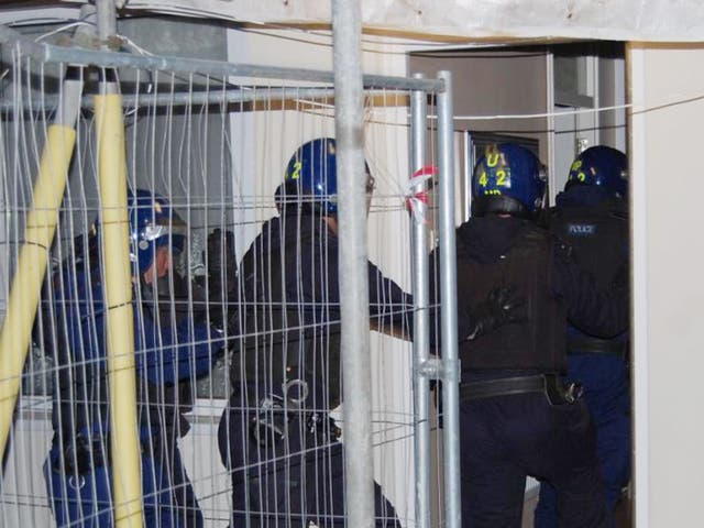 Met officers enter a property during raids as part of Operation Carbon