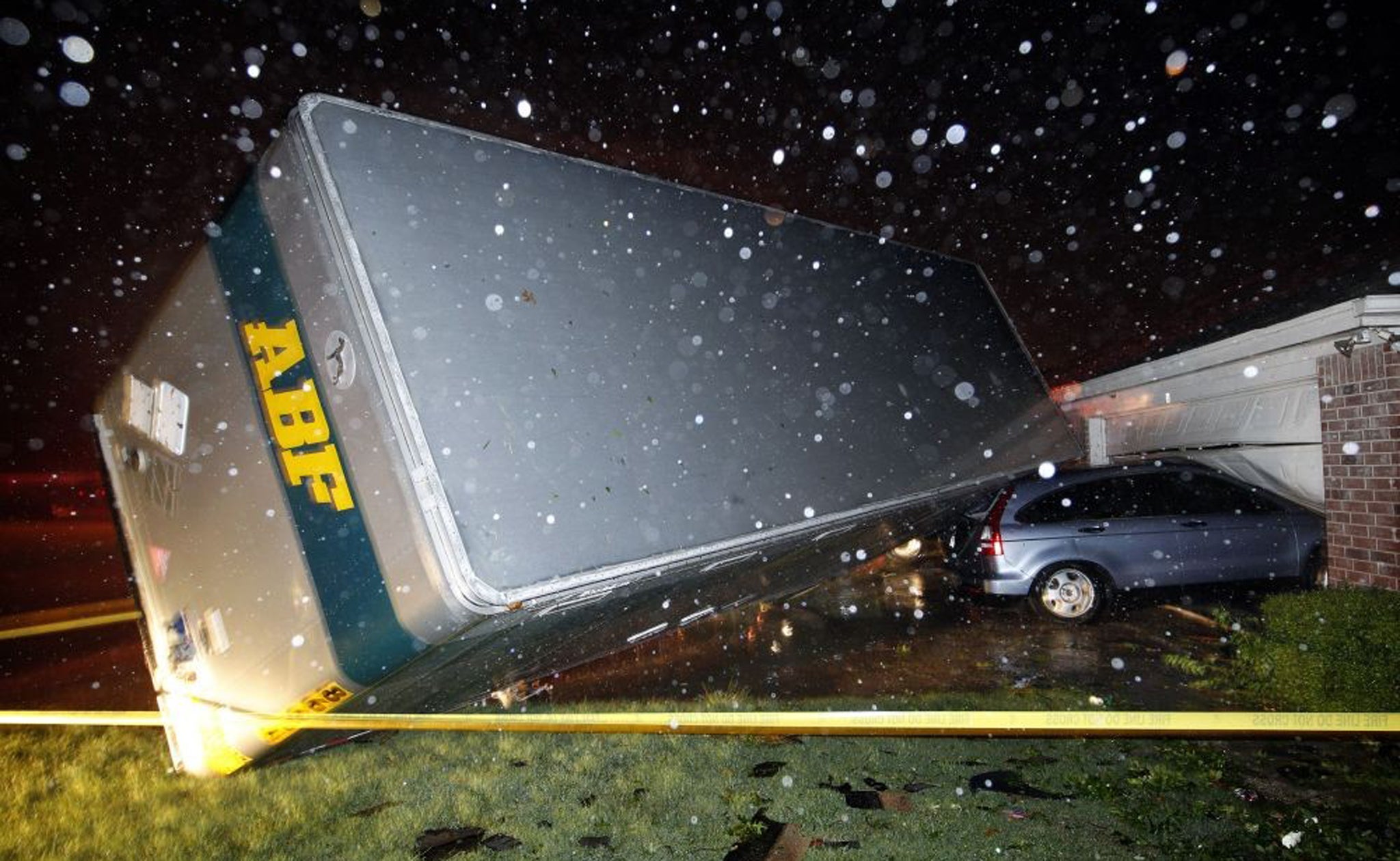 A lorry trailer rolls over on to a car during the storms in Cleburne, south of Forth Worth, Texas