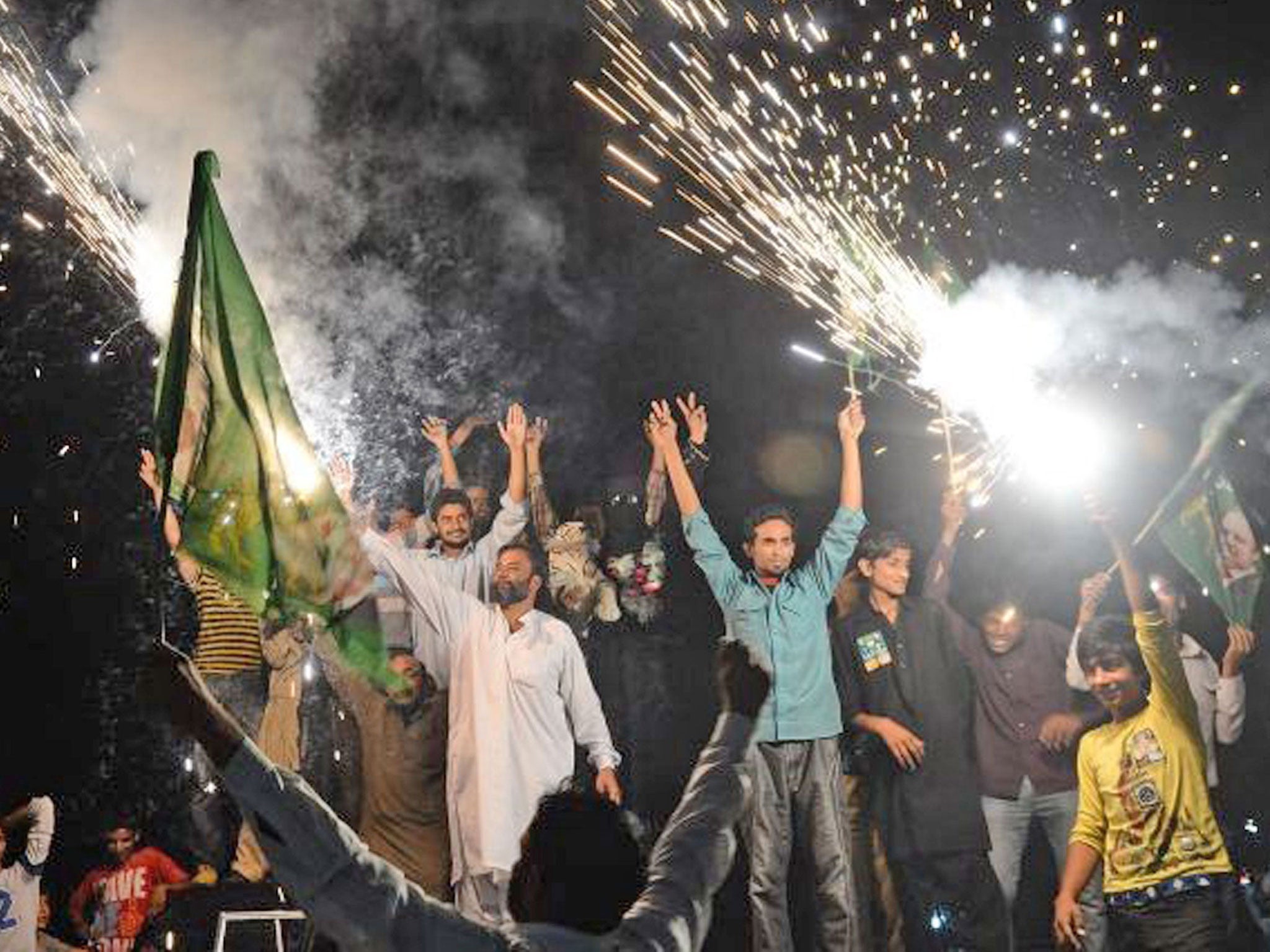 Supporters of former Pakistani Prime Minister and head of the Pakistan Muslim League-N (PML-N), Nawaz Sharif, celebrate with fireworks the victory of their party a day after landmark general elections, in Lahore