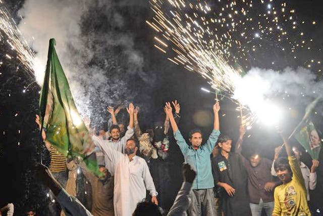 Supporters of former Pakistani Prime Minister and head of the Pakistan Muslim League-N (PML-N), Nawaz Sharif, celebrate with fireworks the victory of their party a day after landmark general elections, in Lahore
