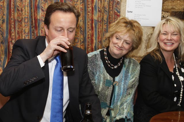 David Cameron (L) drinks a pint of beer at a public house in his constituency in Witney, Oxfordshire, England, in the early hours of Friday, May 7, 2010. 