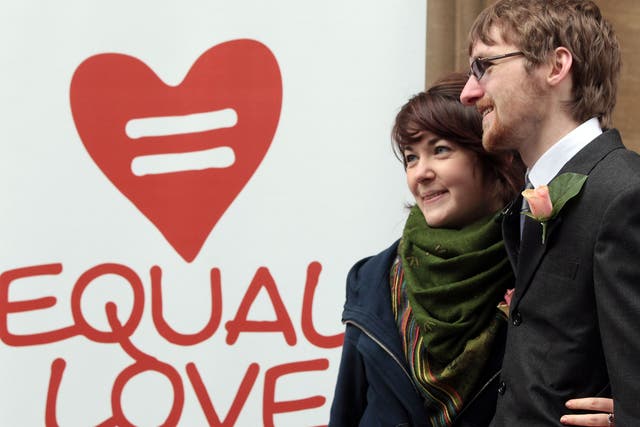 Heterosexual couple, Ian Goggin and Kristin Skarsholt pose for a photograph after being refused a civil partnership outside Bristol Register Office on November 23, 2010 in Bristol, England.