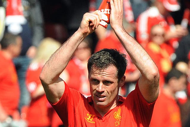 Liverpool's Jamie Carragher applauds at the end of the English Premier League match between Liverpool and Everton at Anfield