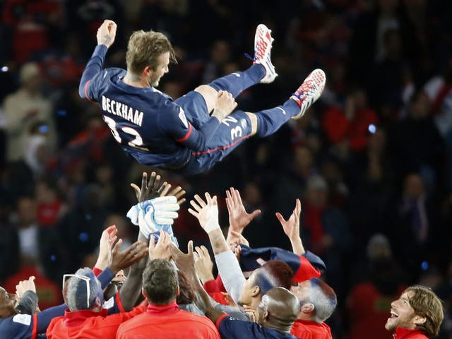 David Beckham is thrown into the air after his last match, with the French team also celebrating the league title (AFP/Getty Images)