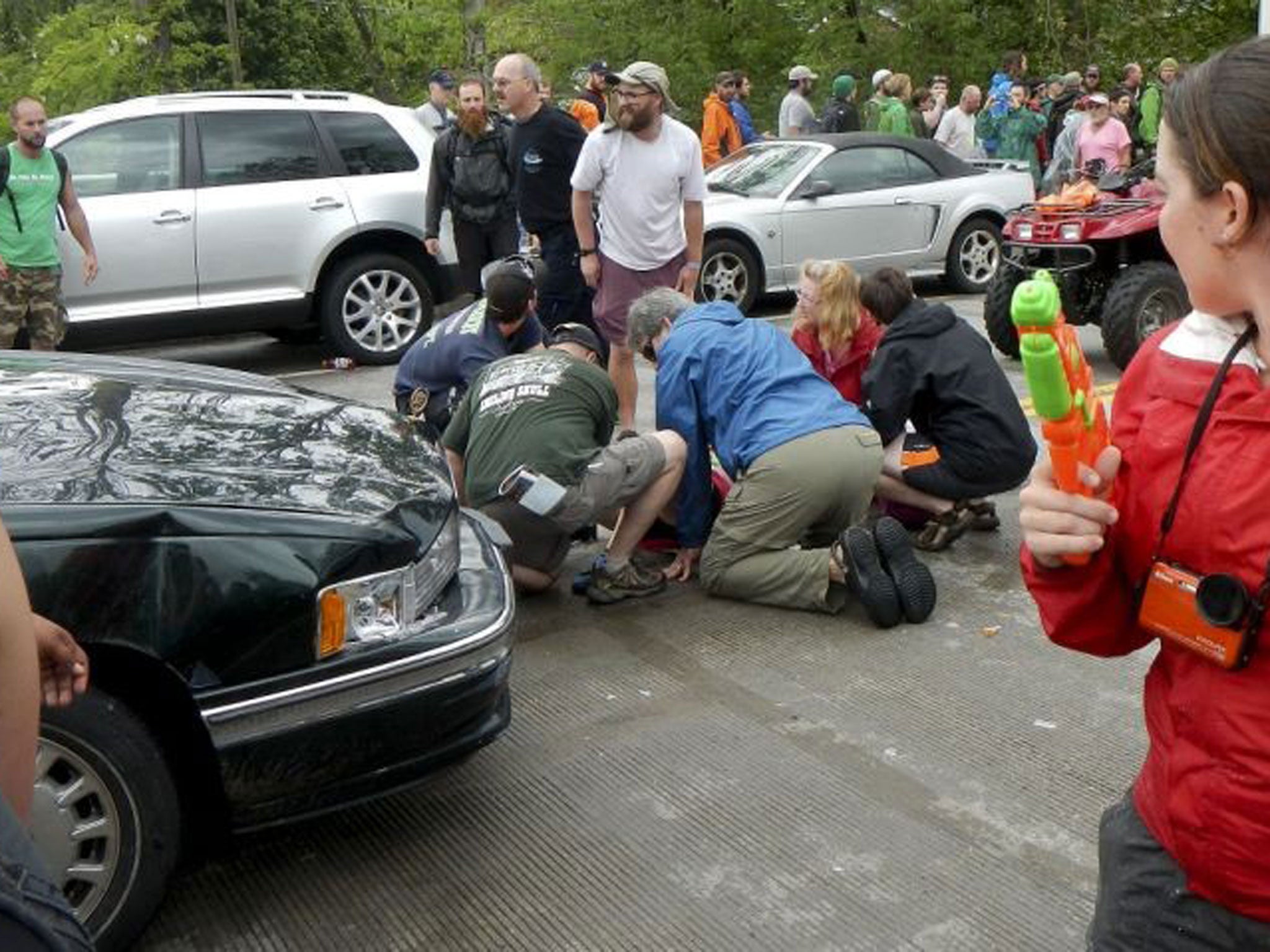 Up to 60 people were injured when a driver described by witnesses as an elderly man drove his car into a group of hikers marching in a parade in a small Virginia mountain town.
