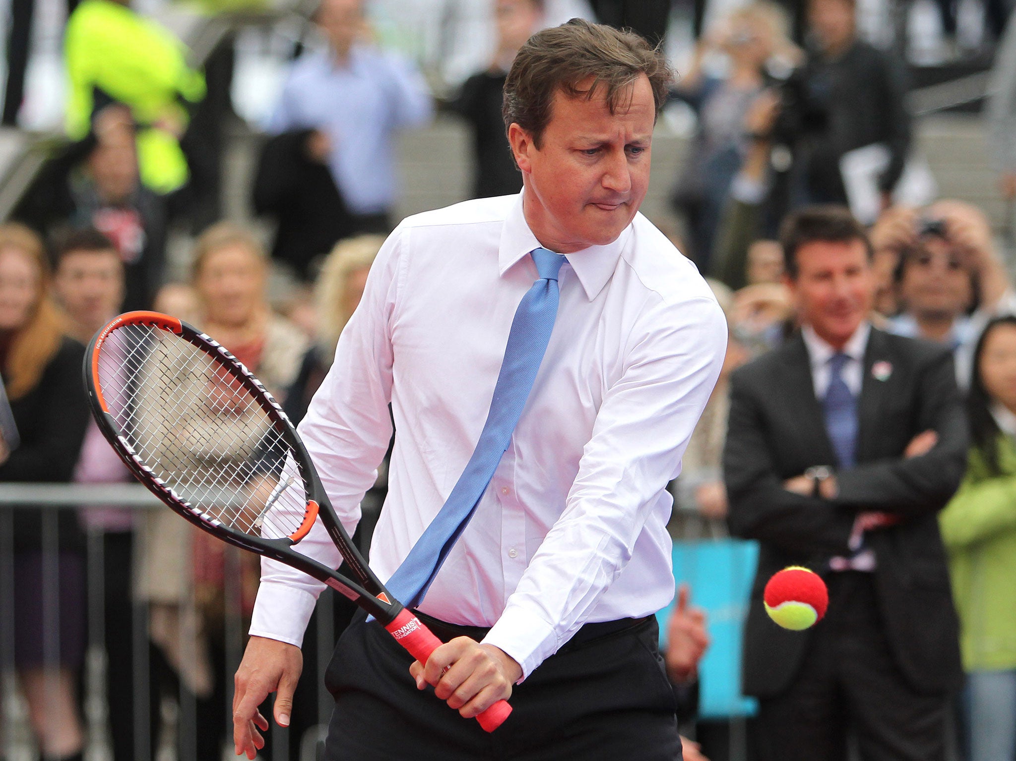 Prime Minister David Cameron plays tennis during the International Paralympic Day at Trafalgar Square on September 8, 2011 in London, England.