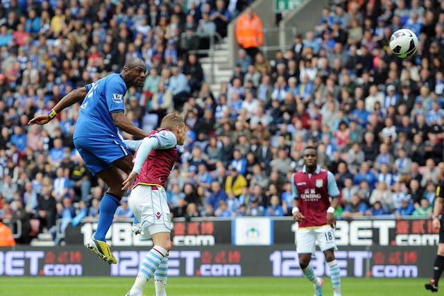 Emmerson Boyce of Wigan Athletic heads his side's first goal during the 2-2 draw with Aston Villa