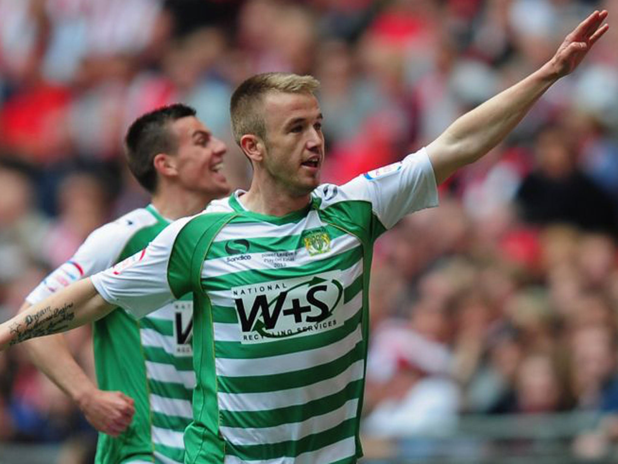 Patrick Madden of Yeovil Town celebrates the opening goal in front of the team's fans