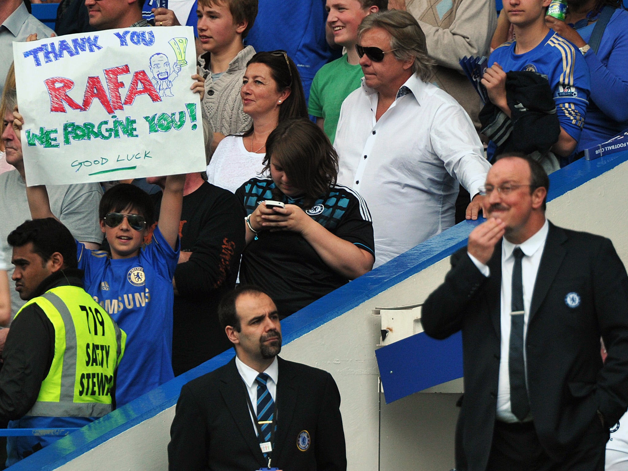 A young fan holds up a banner on the final day of the season