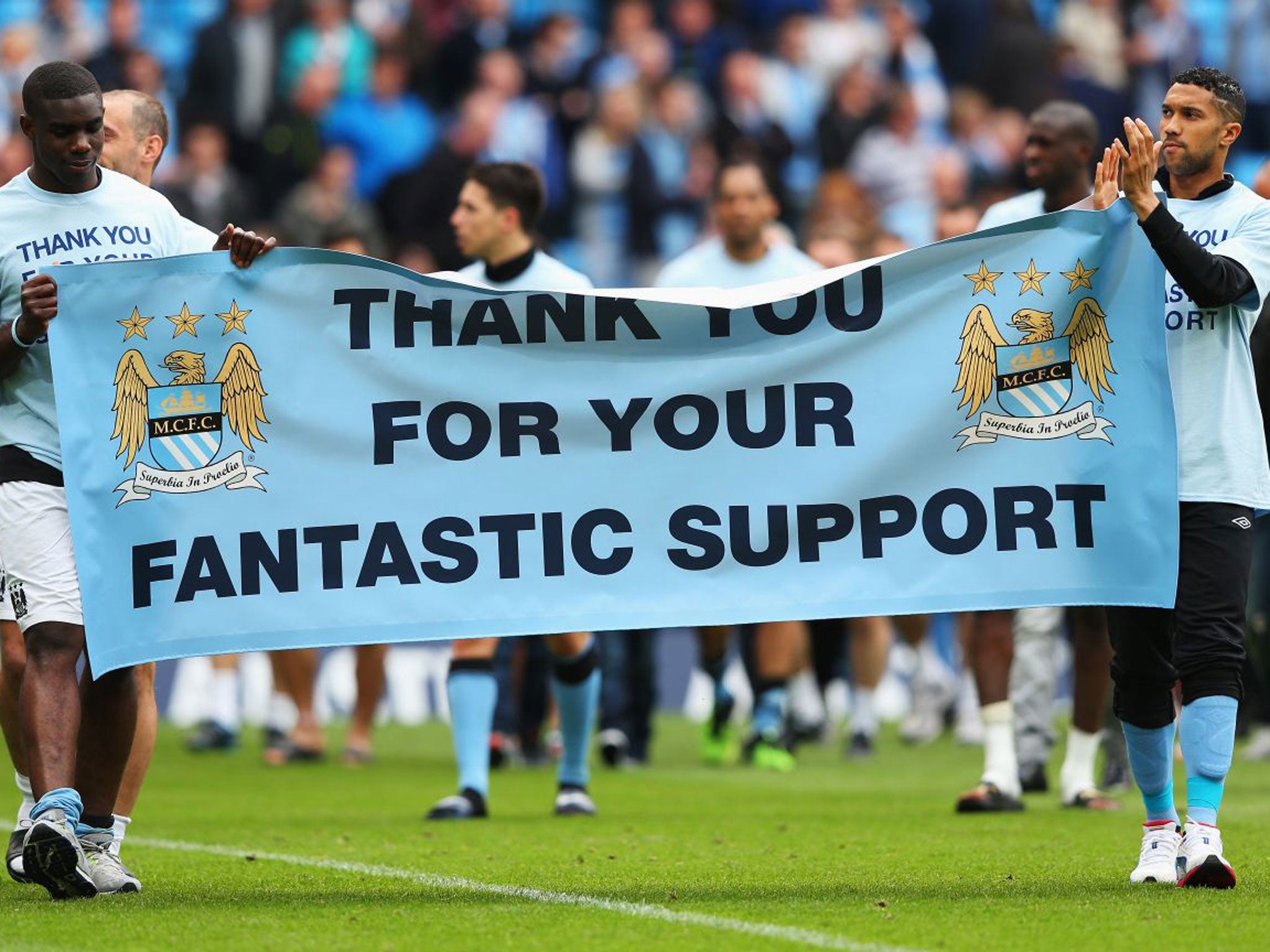 Micah Richards, left, Gael Clichy, right, and the rest of the Manchester City players thank their fans for their support