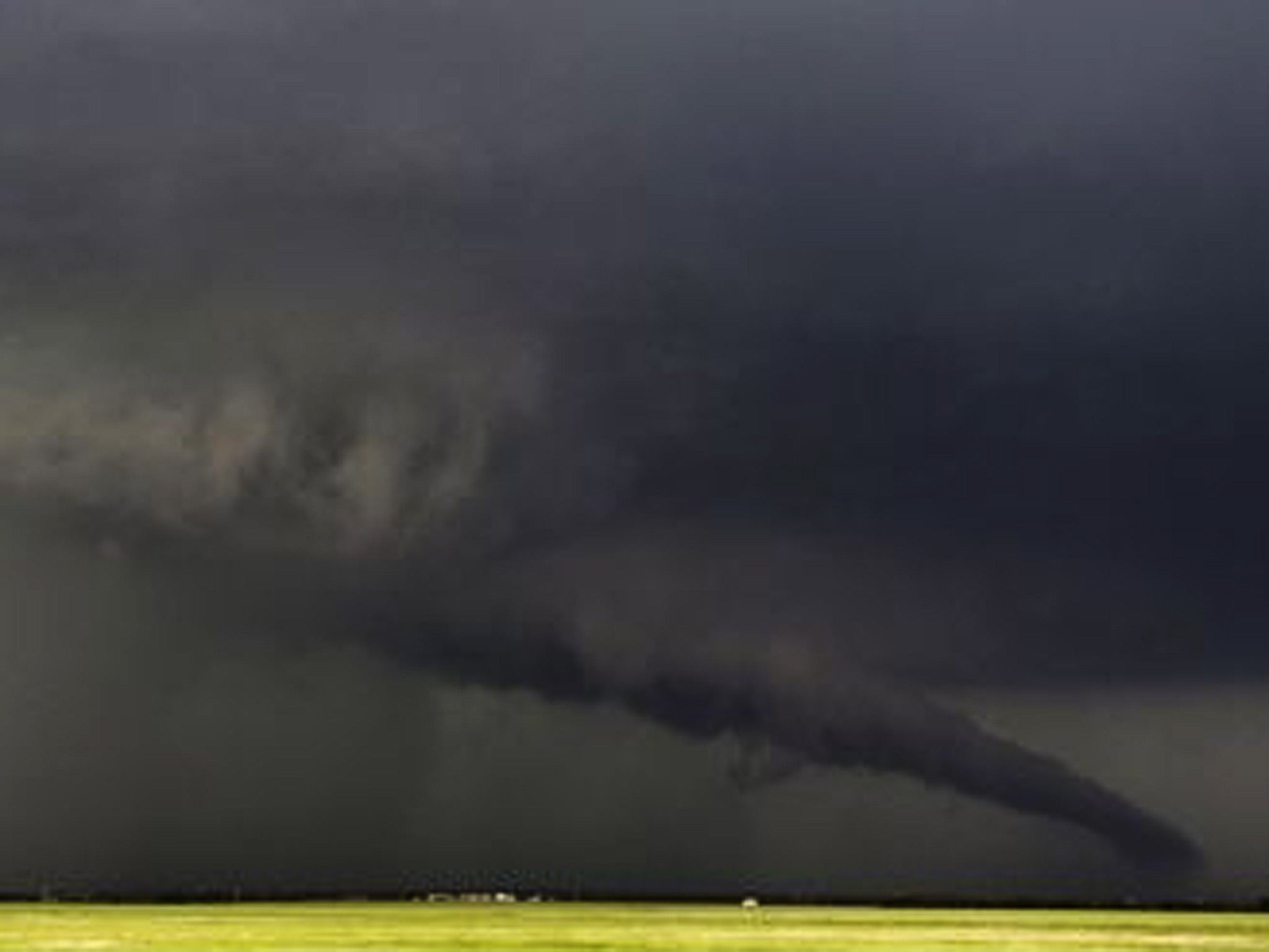 The funnel of a tornado almost touches the ground yesterday near South Haven, Oklahoma
