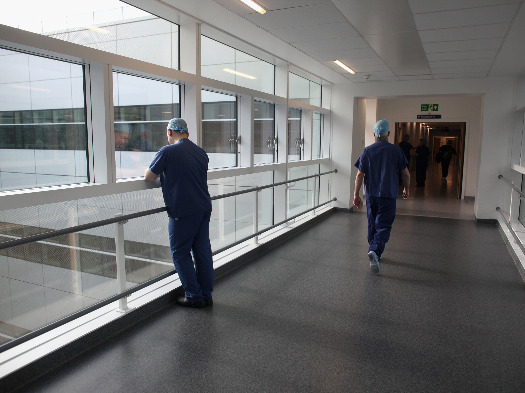 Operating theatre staff walk along a corridor in the recently opened Birmingham Queen Elizabeth Hospital on February 7, 2011 in Birmingham, England.