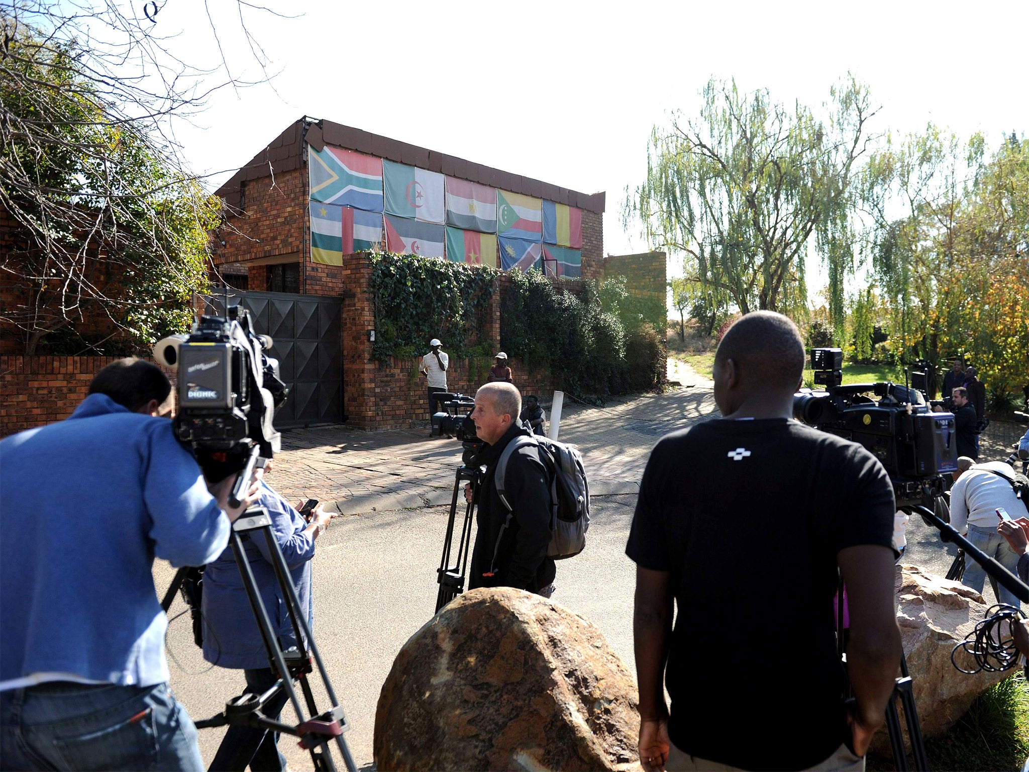 Reporters gather outside the house of Winnie Madikizela-Mandela