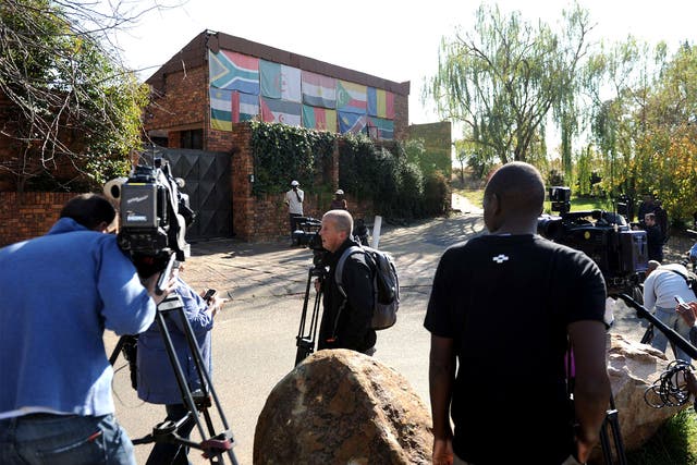 Reporters gather outside the house of Winnie Madikizela-Mandela 