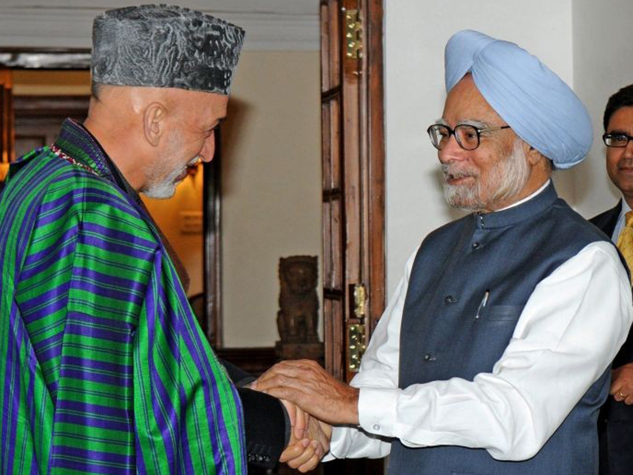Hamid Karzai, left, is on a two-day visit to India during which he has sought to build on an agreement signed in 2011. Pictured right is Indian prime minister Manmohan Singh