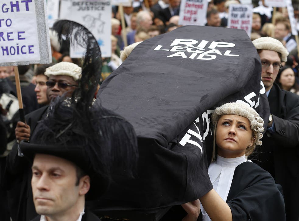22 May 2013: Lawyers carry a coffin during a mock funeral procession at a protest against proposed cuts to legal aid outside the Houses of Parliament