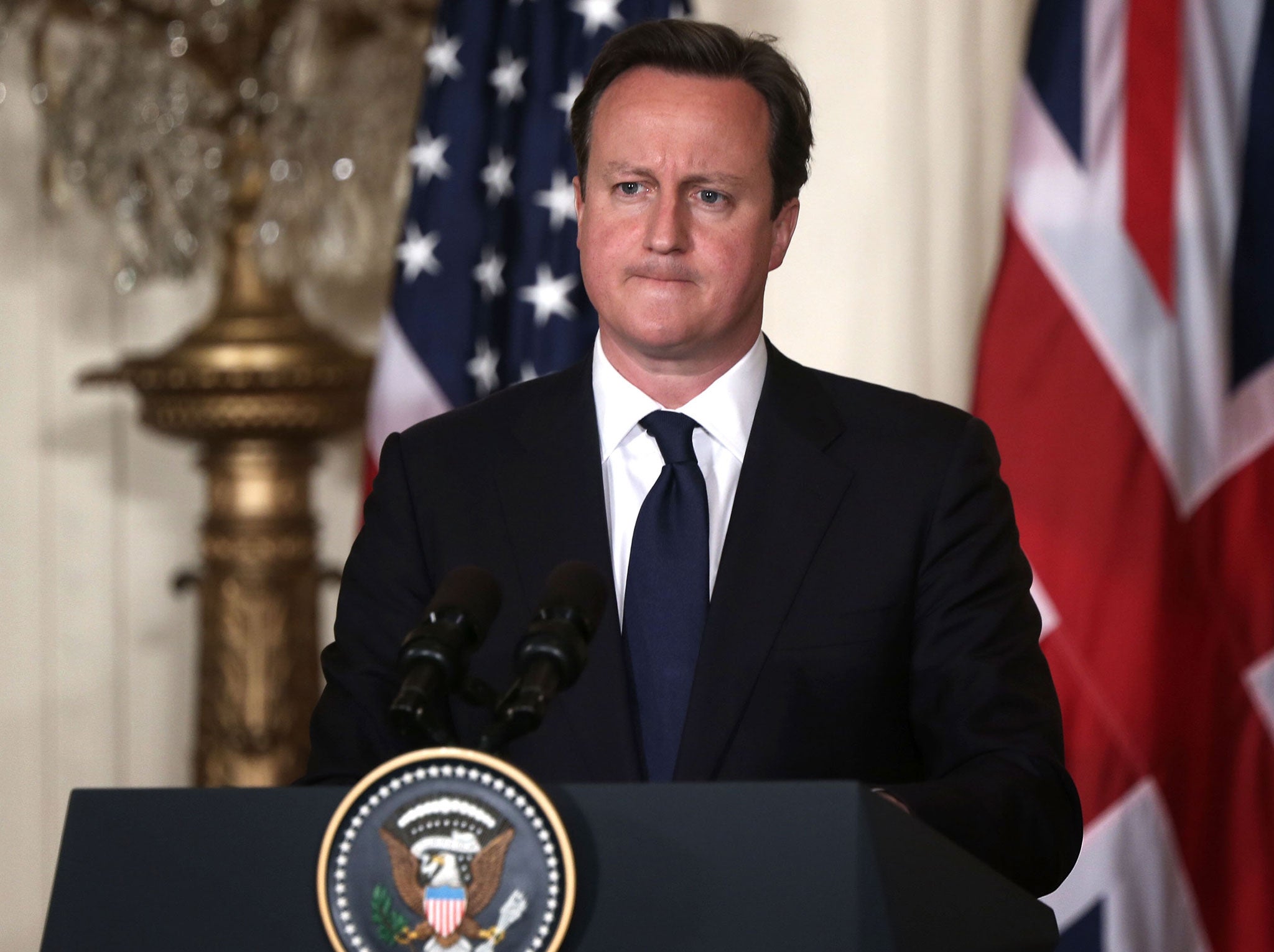 British Prime Minister David Cameron pauses during a joint news conference with U.S. President Barack Obama in the East Room of the White House May 13, 2013 in Washington, DC.