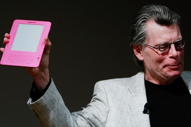 Author Stephen King holds a special pink Kindle given to him by Amazon.com founder and CEO Jeffrey P. Bezos at an unveiling event for the Amazon Kindle 2 at the Morgan Library & Museum February 9, 2009 in New York City.