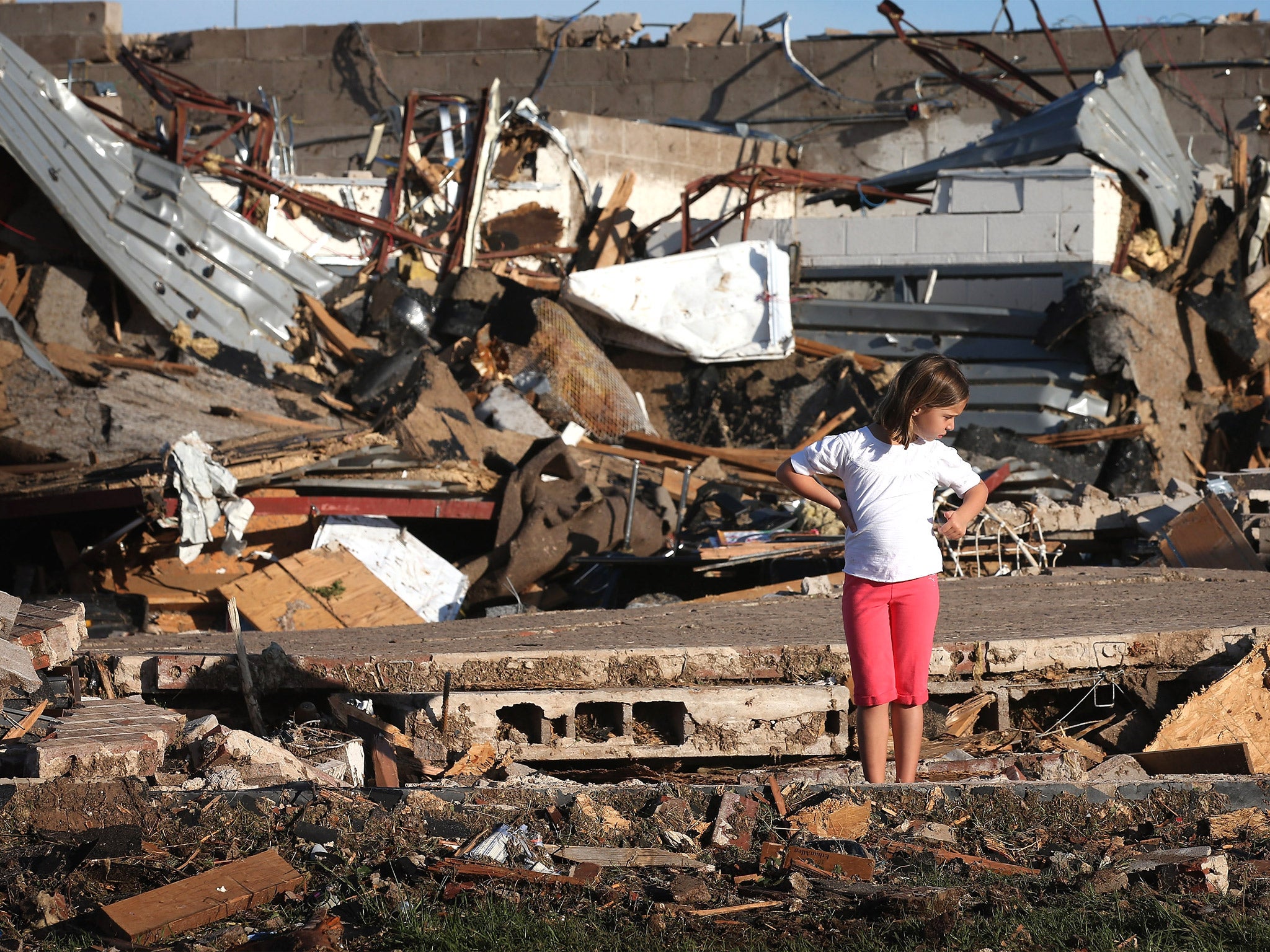 A child looks over damage at Briarwood Elementary School