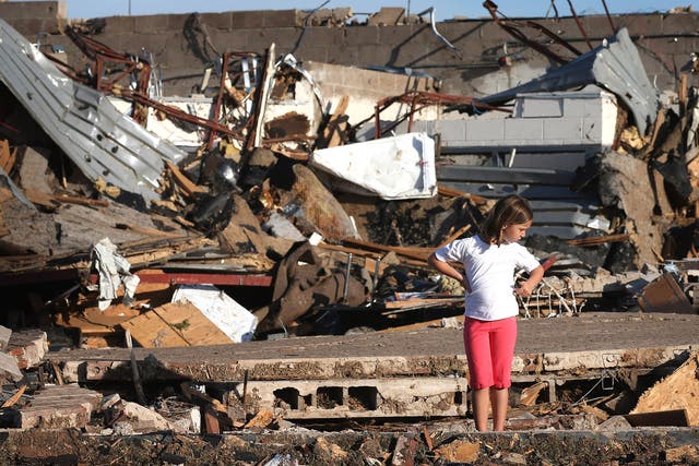 A child looks over damage at Briarwood Elementary School 