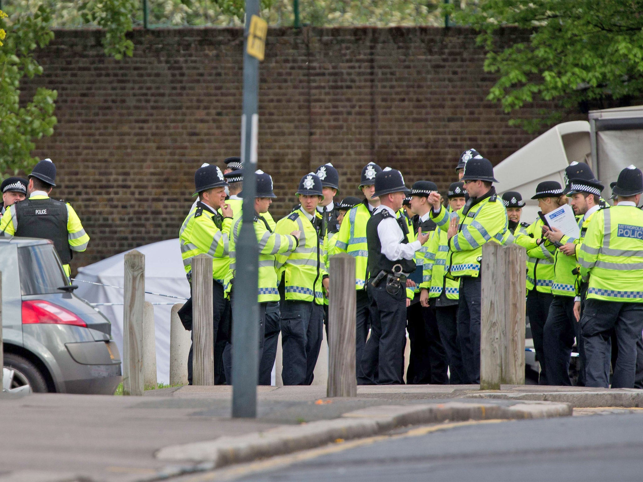 Police officers man a cordoned off area in Woolwich