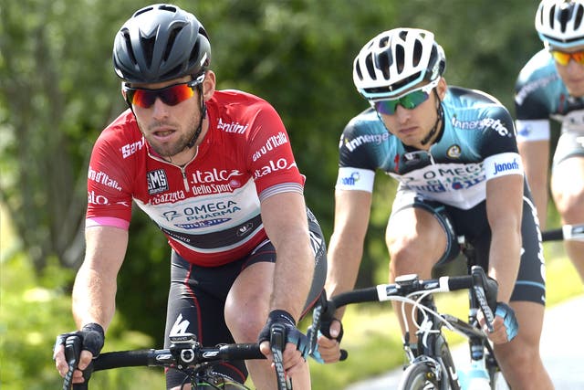 Mark Cavendish (left) tries to keep up in the points leader’s red jersey yesterday