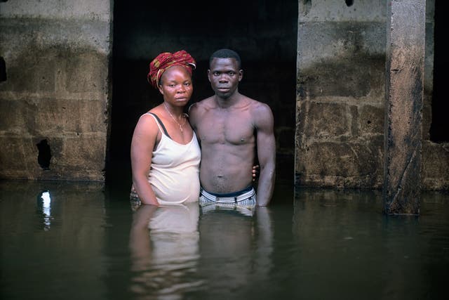 Victor and Hope America pose for a portrait waist-deep in water at their home in Bayelsa State, Nigeria, 2012