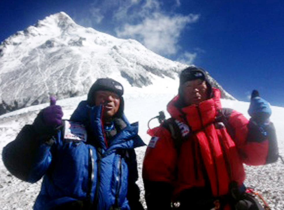 Eighty-year-old Japanese adventurer Yuichiro Miura (R) and his son Gota (L) posing for a picture as they leave the C4 camp to ascent to the summit of Mount Everest in Nepal