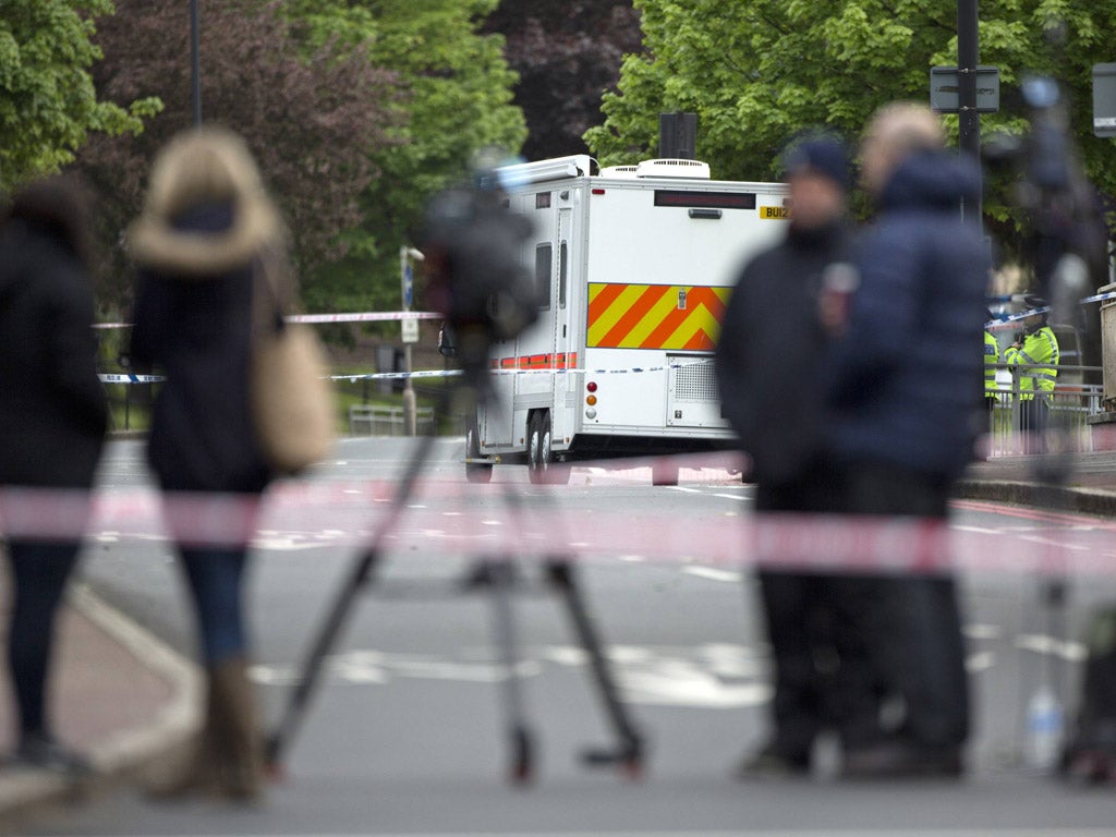 Members of the media stand near the scene where a British soldier was killed in Woolwich, southeast London