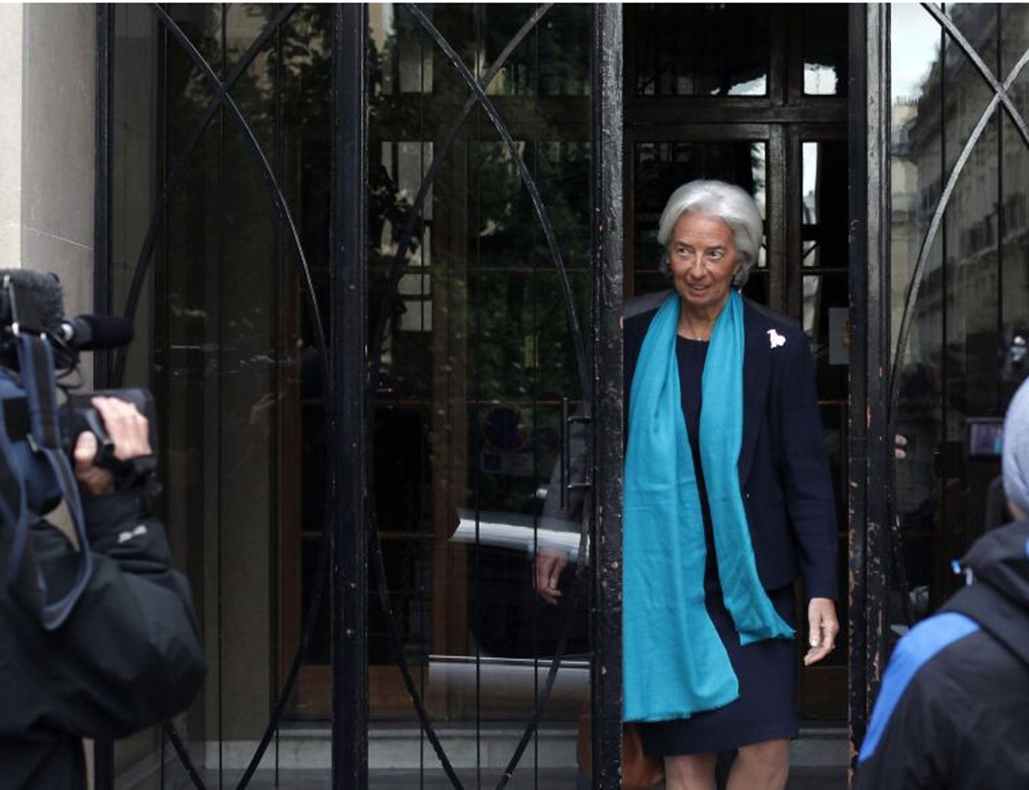 IMF Managing Director Christine Lagarde leaves her apartment building before appearing in a Paris court