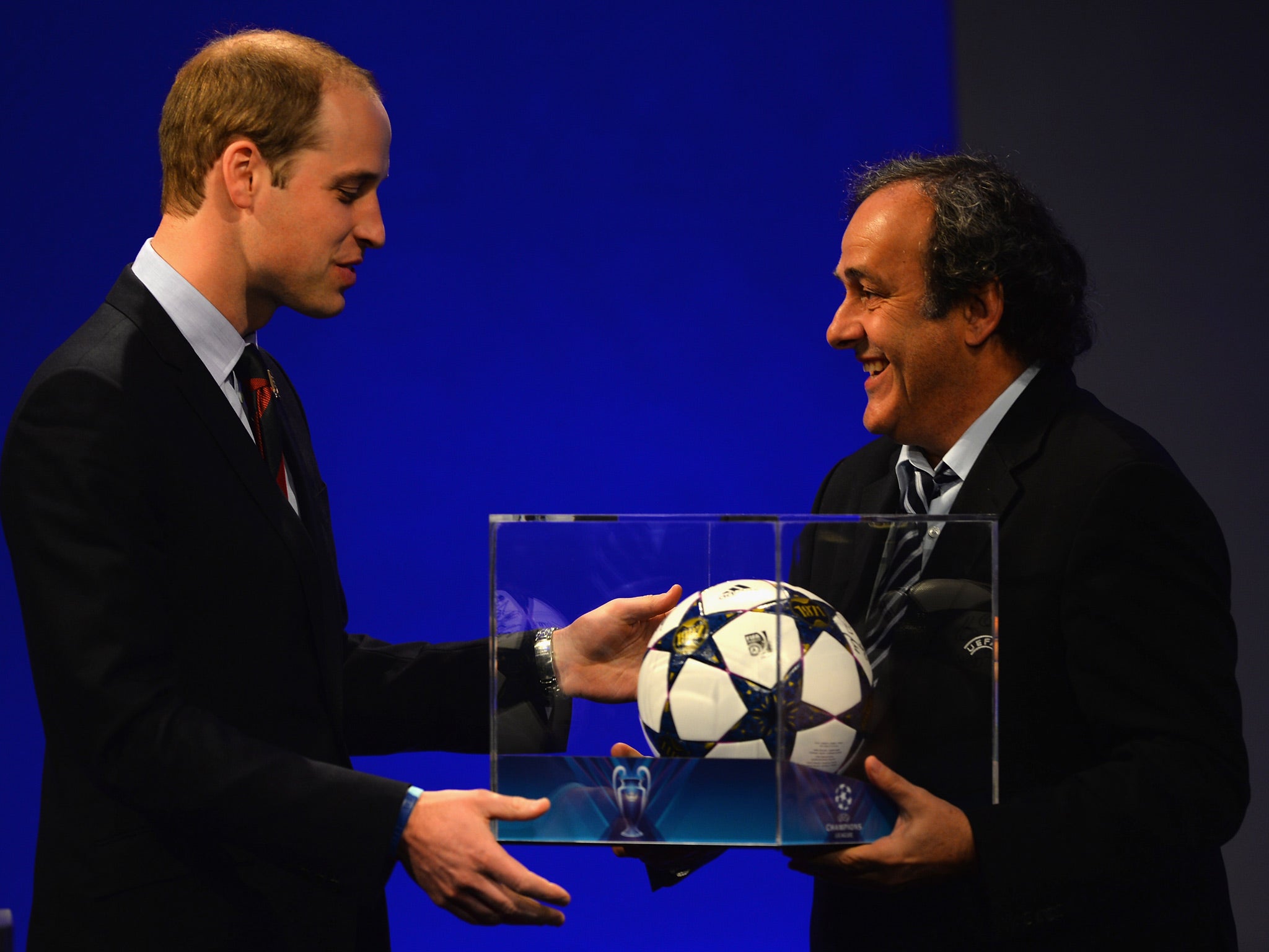 President of The FA Prince William, Duke of Cambridge is presented a match ball by UEFA President Michel Platini
