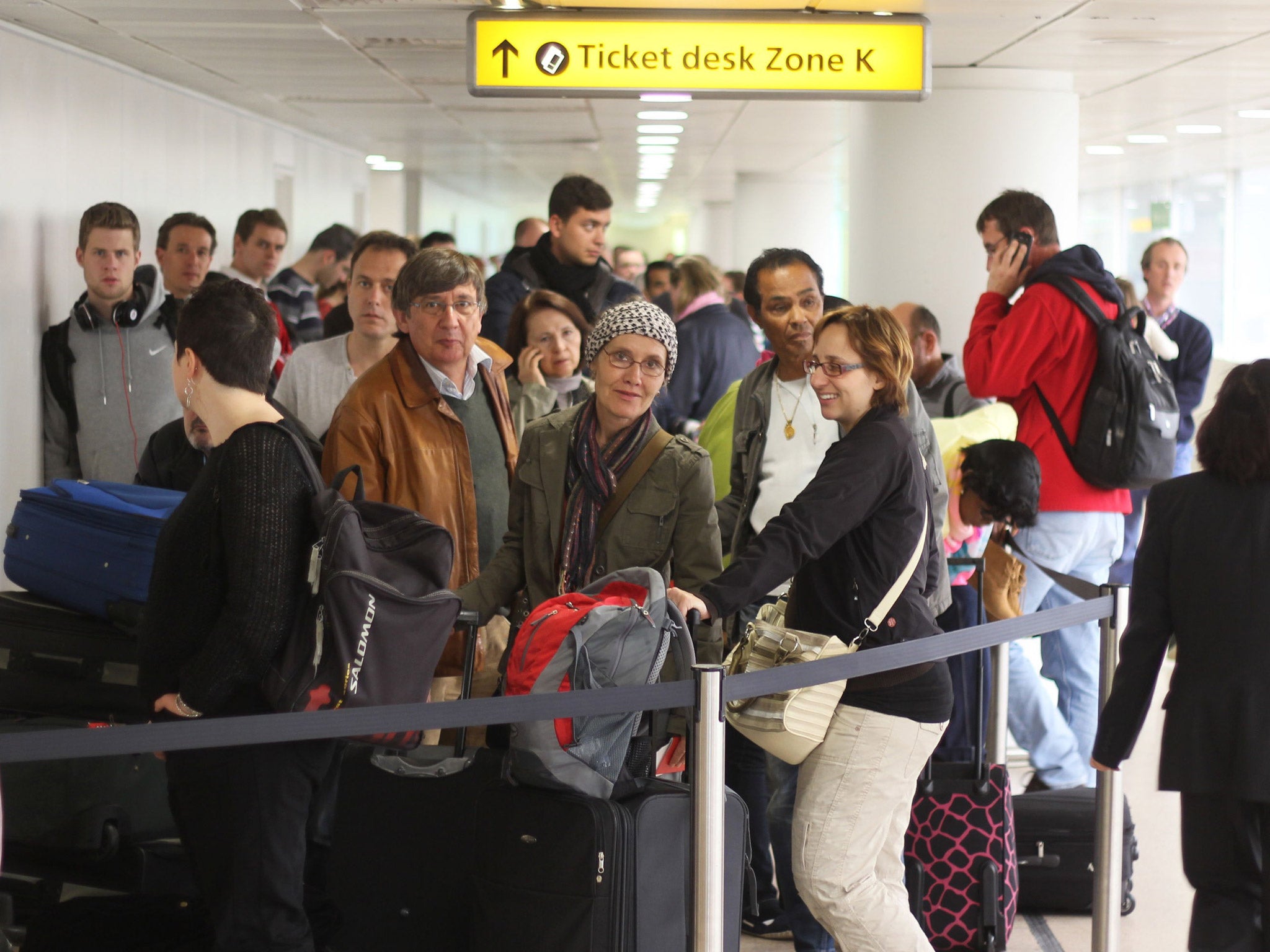 Passengers wait in Heathrow Terminal One