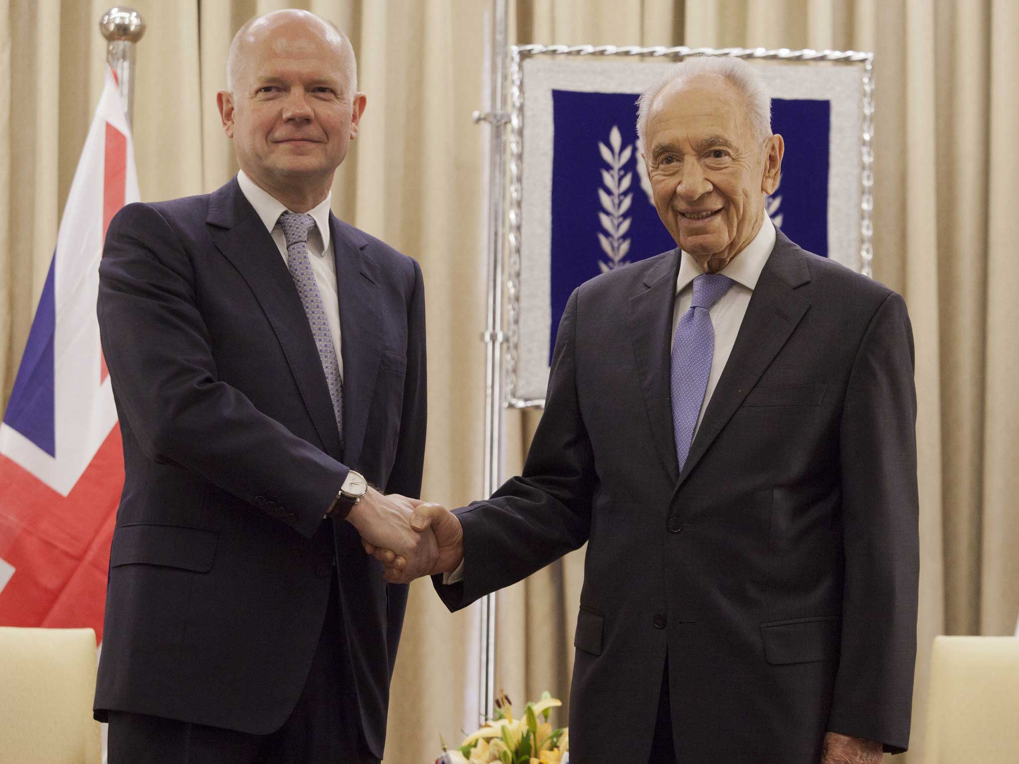 William Hague, left, shakes hands with Israeli President Shimon Peres