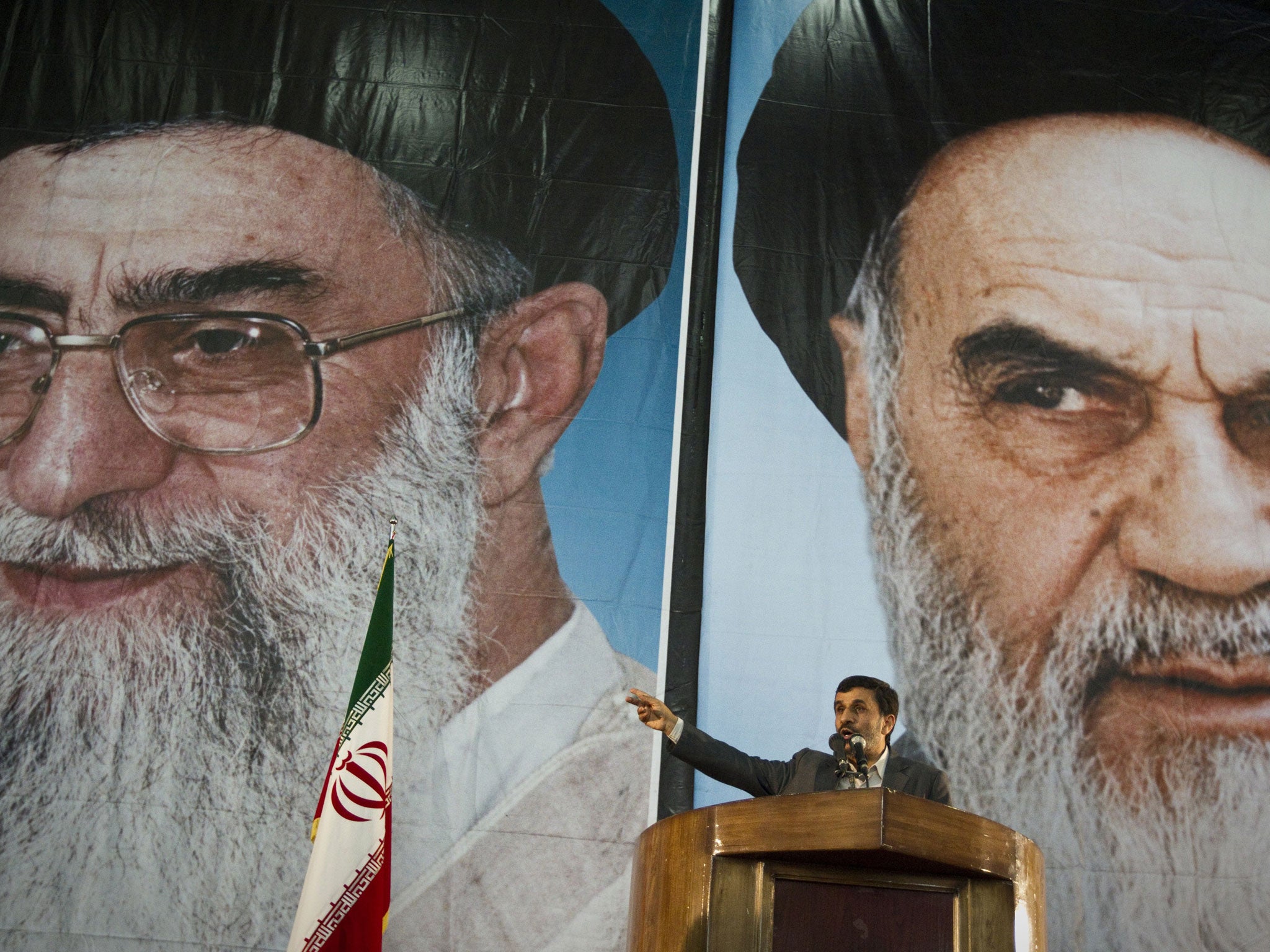 President Ahmadinejad is dwarfed by posters of the Supreme Leader, Ayatollah Ali Khamenei, left, and Ayatollah Ruhollah Khomeini