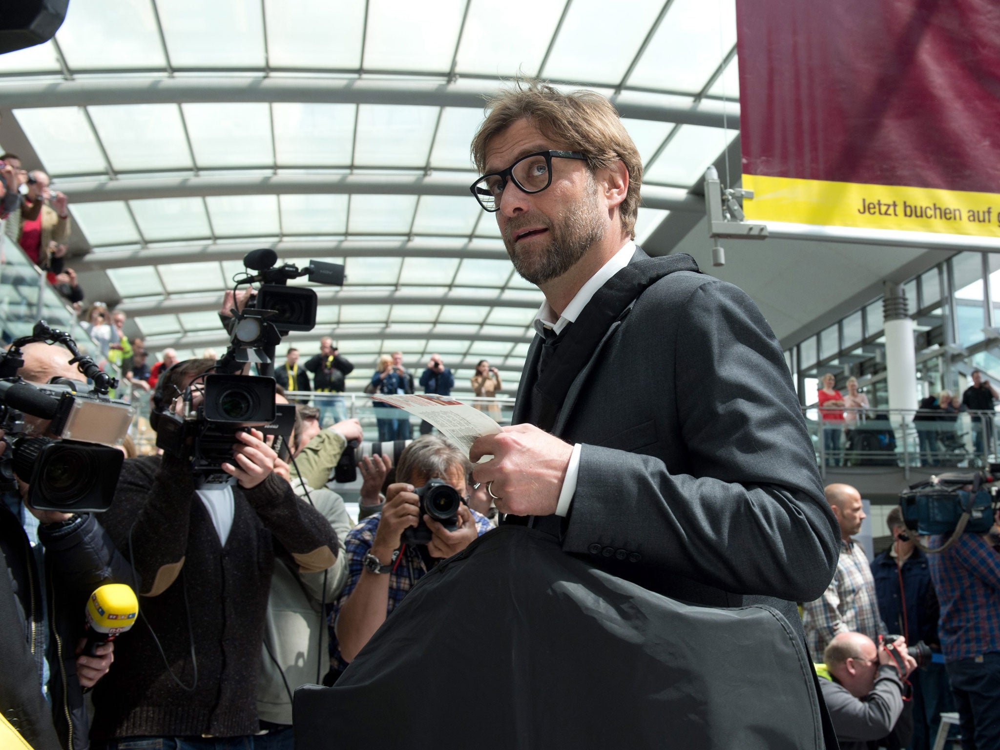 Jürgen Klopp checks in at Dortmund airport on his way to London