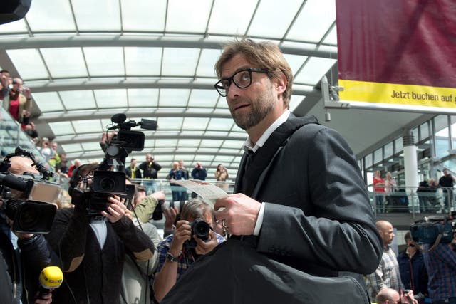 Jürgen Klopp checks in at Dortmund airport on his way to London