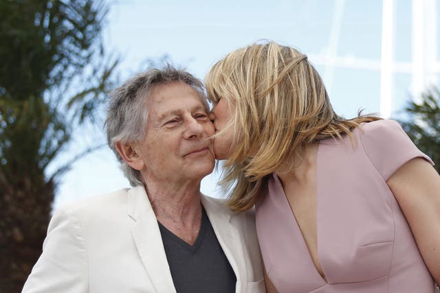 Emmanuelle Seigner and Roman Polanski kiss at the Cannes Film Festival yesterday 