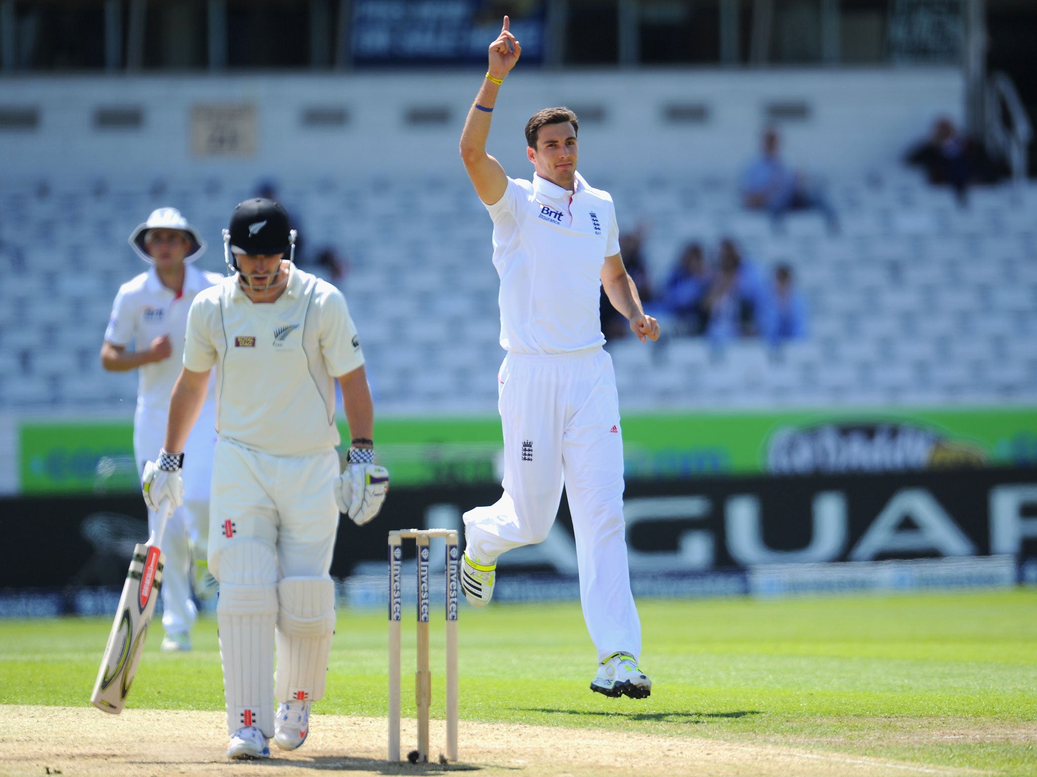 England bowler Steven Finn celebrates after taking the wicket of Hamish Rutherford