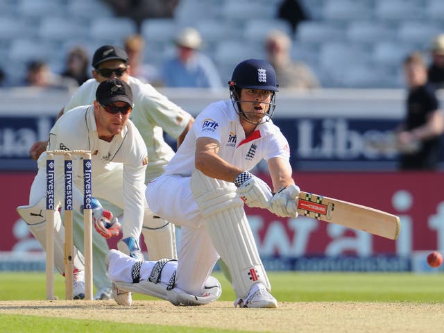 Alastair Cook prepares to sweep watched by wicketkeeper Brendon McCullum