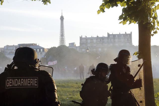 Riot police officers take position (Laurent Cipriani/AP)