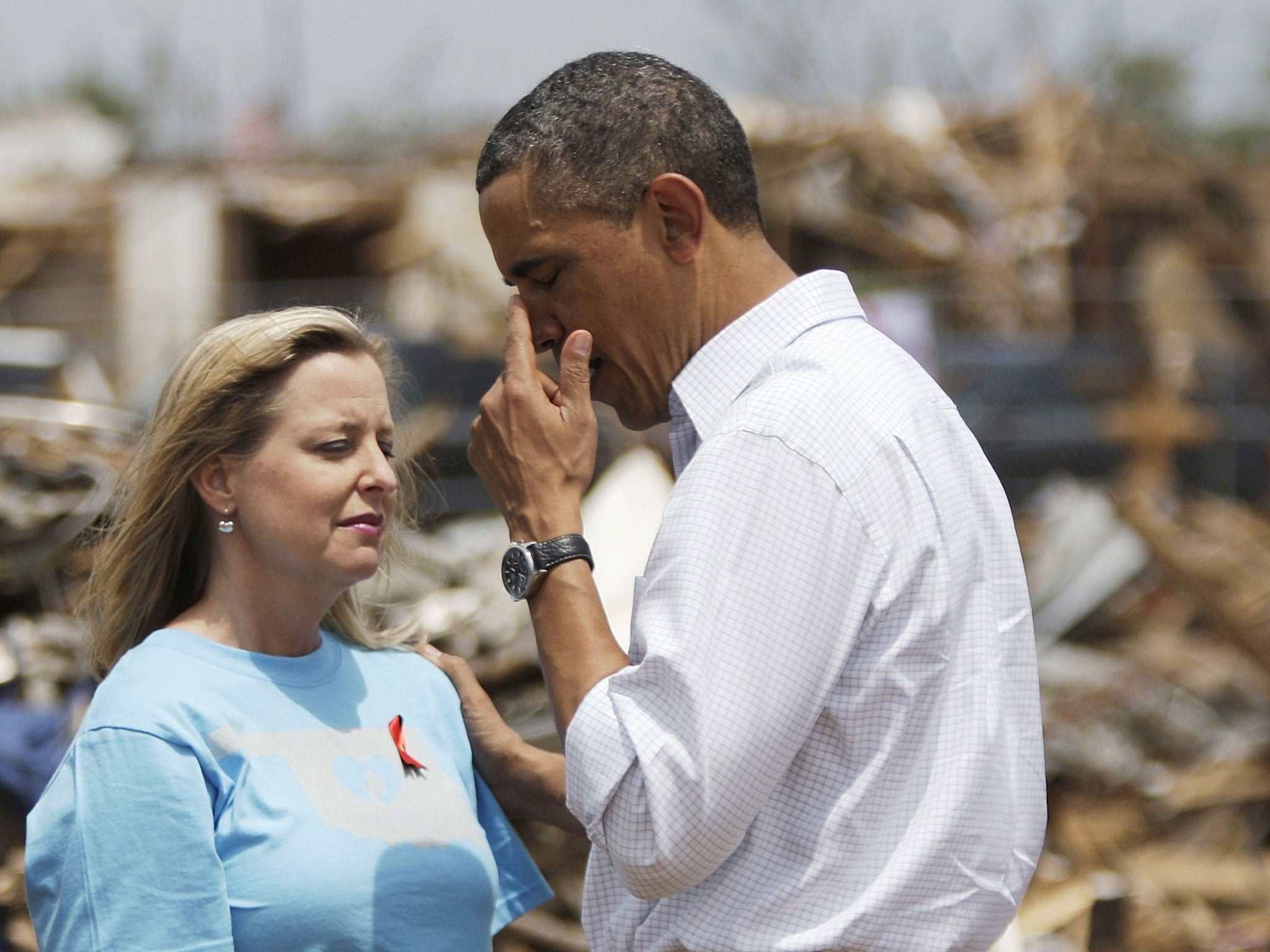 Barack Obama wipes away tears after hugging head teacher Amy Simpson
