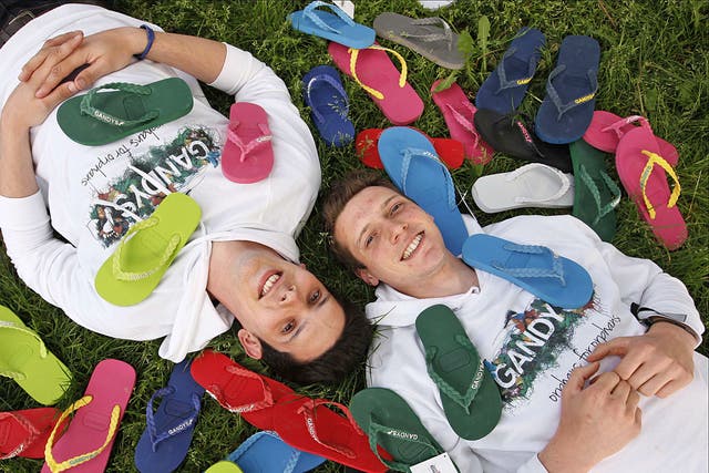 Finding their feet: Rob (left) and Paul Forkan with the flip-flops they sell for their charity