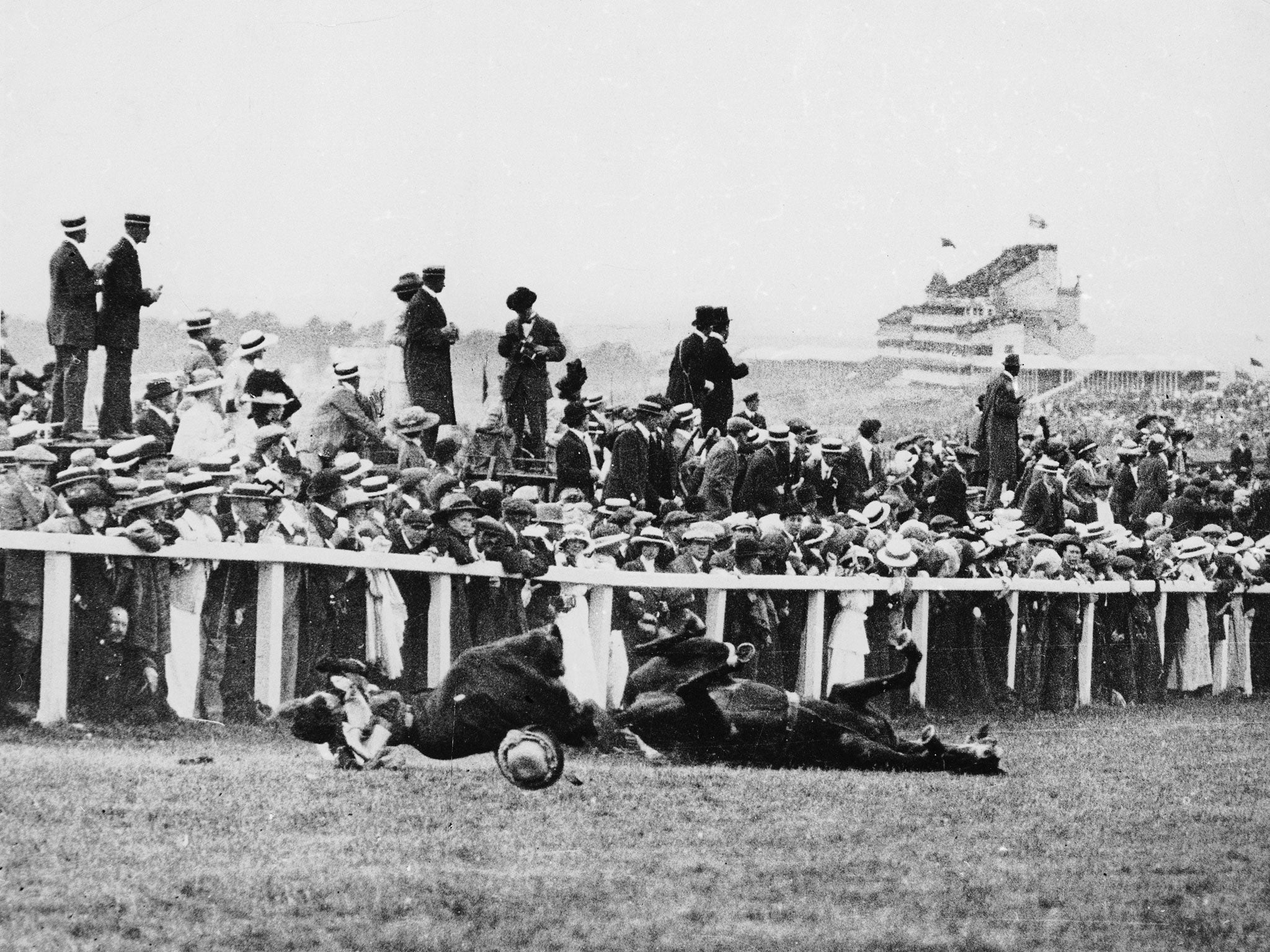 Emily Davison lies fatally injured after being struck by the King’s horse, Anmer, in the 1913 Derby