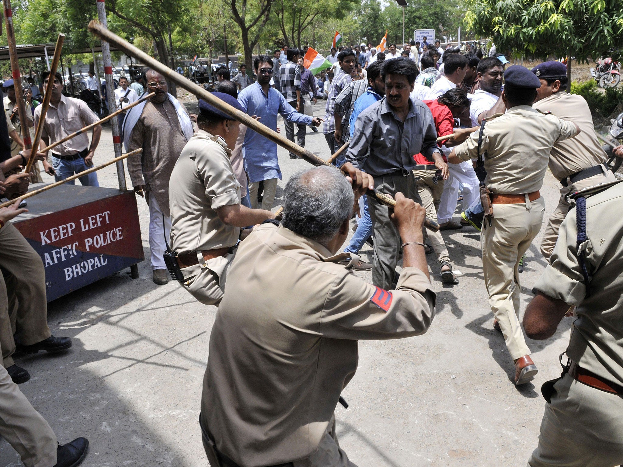 Congress party workers clash with police at a protest after the rebel attack