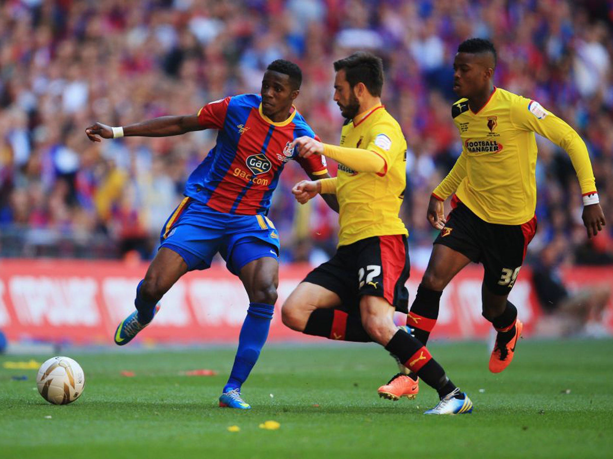 Wilfried Zaha of Crystal Palace is chased by Nathaniel Chalobah, right, and Marco Cassetti of Watford, centre, during the npower Championship Play-off Final match between Watford and Crystal Palace at Wembley Stadium