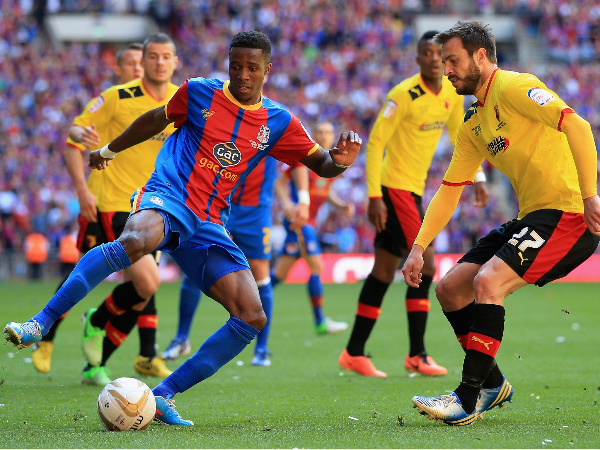 Wilfried Zaha, left, takes on Marco Cassetti, right
