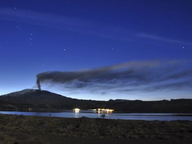 A plume of ash and smoke rises from the Copahue volcano