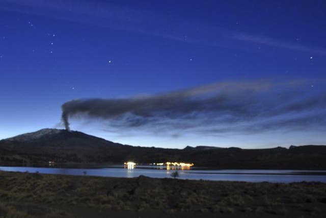 A plume of ash and smoke rises from the Copahue volcano